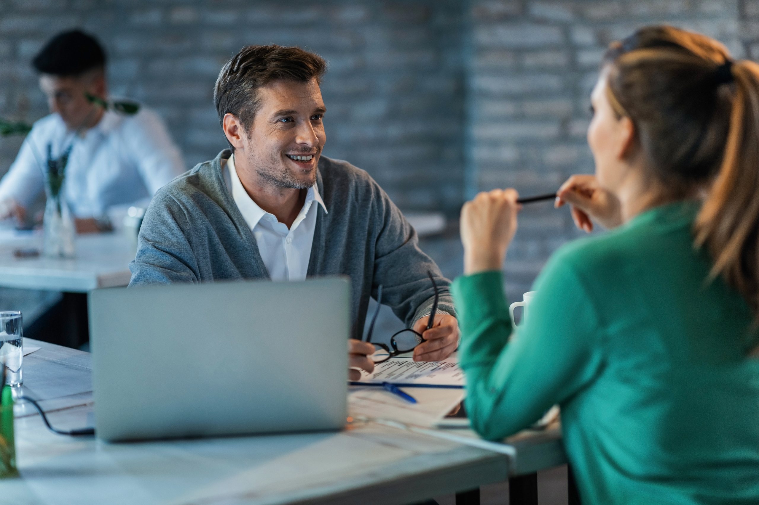 Asesor de APR Brokers revisando opciones de crédito con una clienta